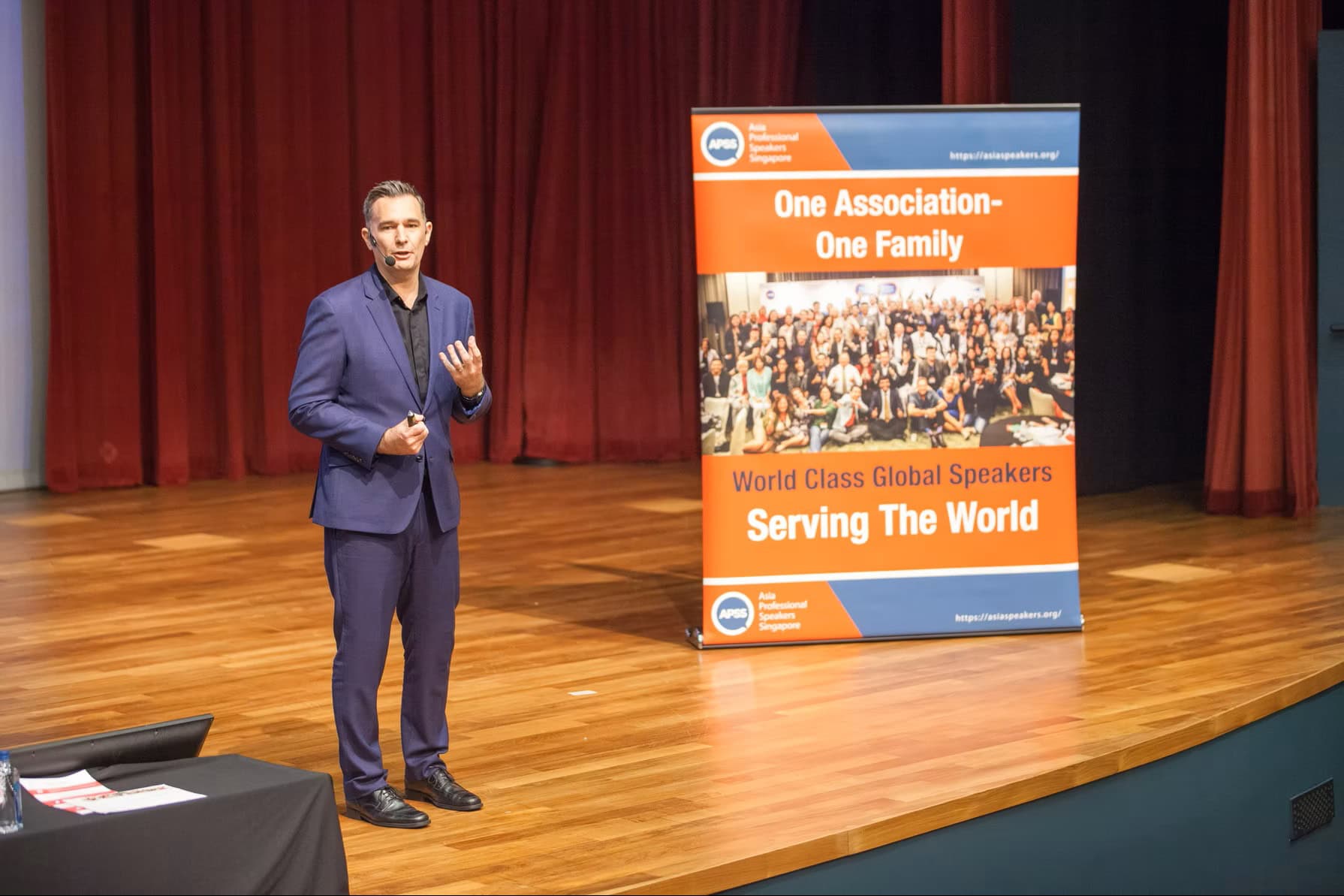 Mark Stuart speaking on stage at an APSS event