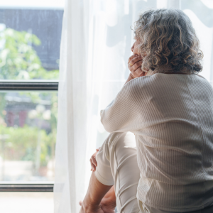 An elderly woman, with a contemplative expression, gazes out of a window. - Child Promises Elderly Mom A Dream And Delivers A Nightmare Removal Of Power Of Attorney Agent