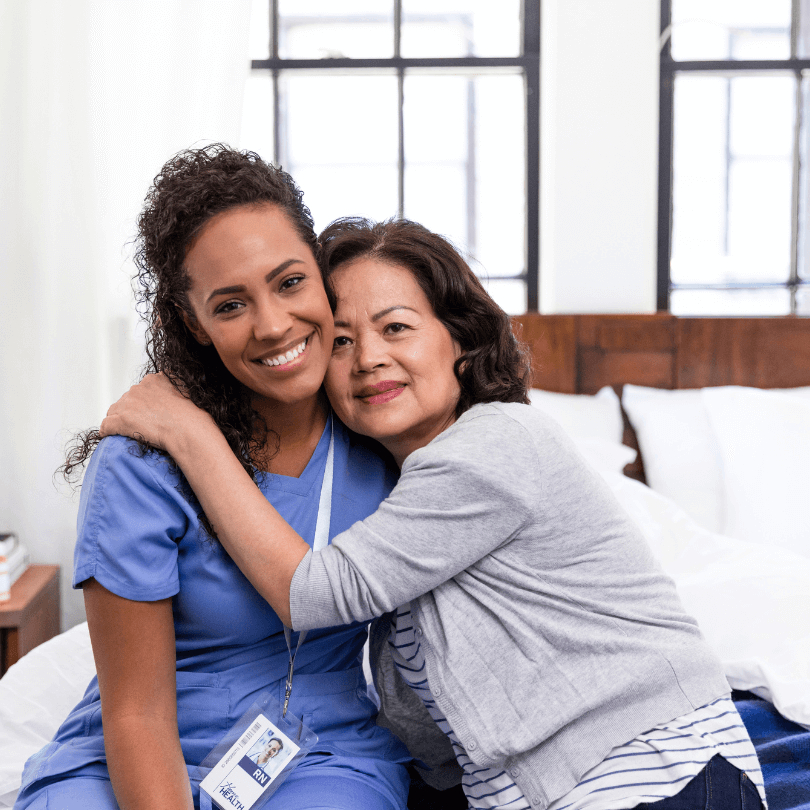 Smiling caregiver and elderly woman embracing in a Dallas nursing home – Medicaid application support by Michael B. Cohen, Elder Law Attorney