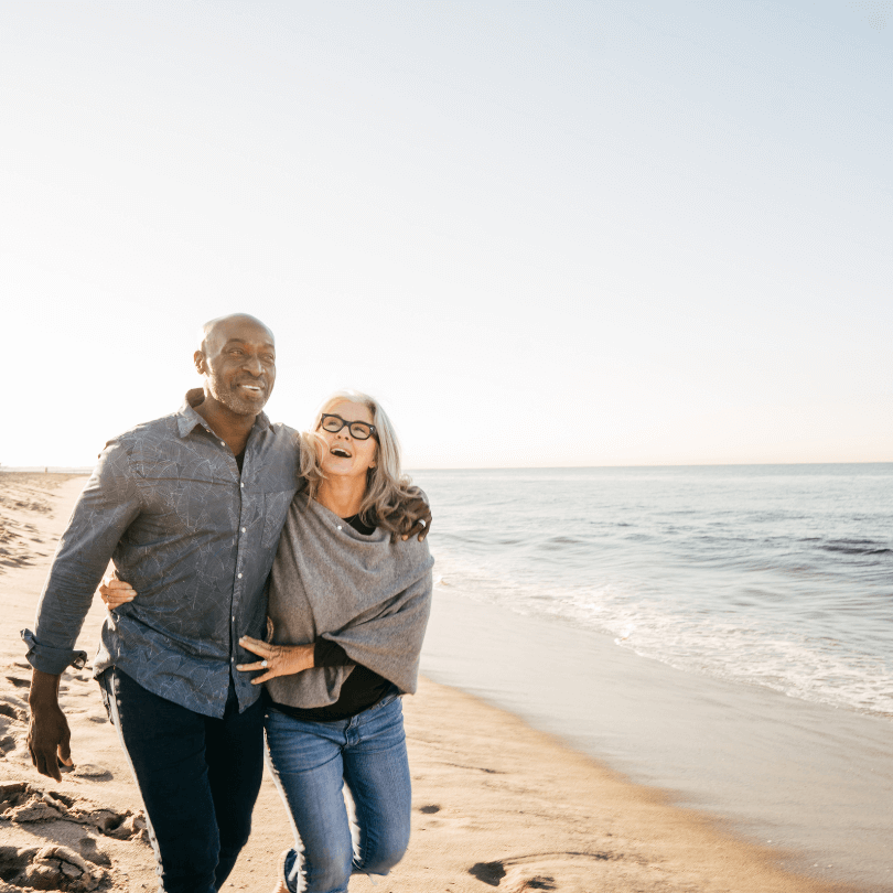 Smiling couple walking on a Dallas beach discussing the 5 types of powers of attorney – Michael B. Cohen, Elder Law Attorney