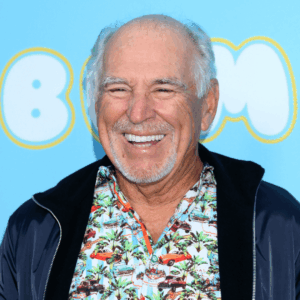 Jimmy Buffett smiling, featured in an article about his estate planning and the lawsuit between his co-trustees.
