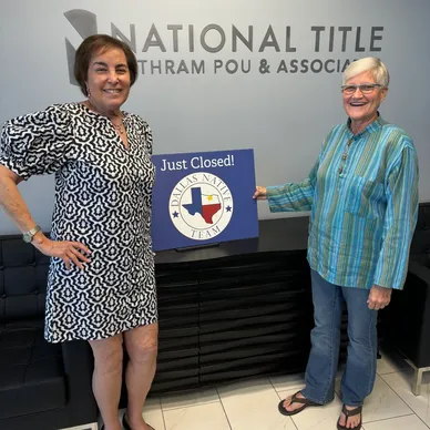 Mary Beth Harrison with client holding 'Just Closed' sign in North Texas.