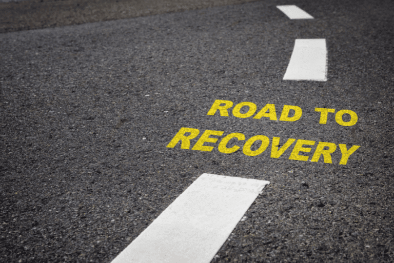 Road with the words "Road to Recovery" symbolising addiction recovery journey.