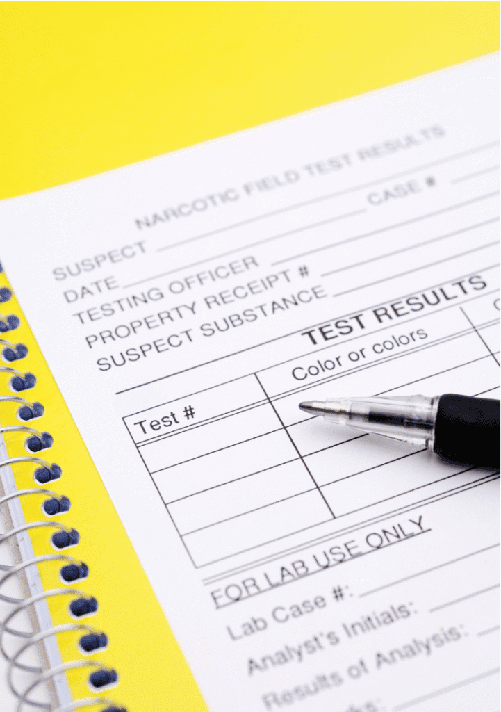 Close-up of a narcotic field test results form with a pen, symbolising drug screening and diagnosis.