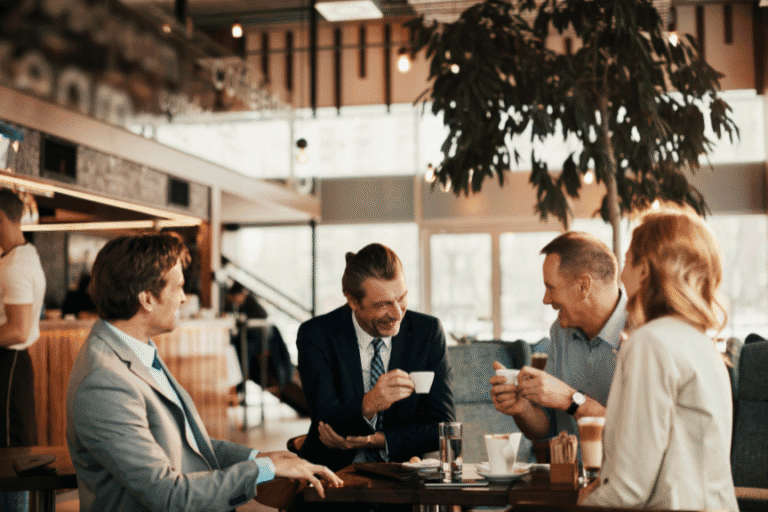 Confident adults in a smart setting, connecting over coffee and conversation.