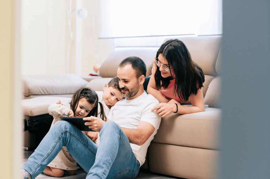 Smiling family relaxing together on a sofa at home