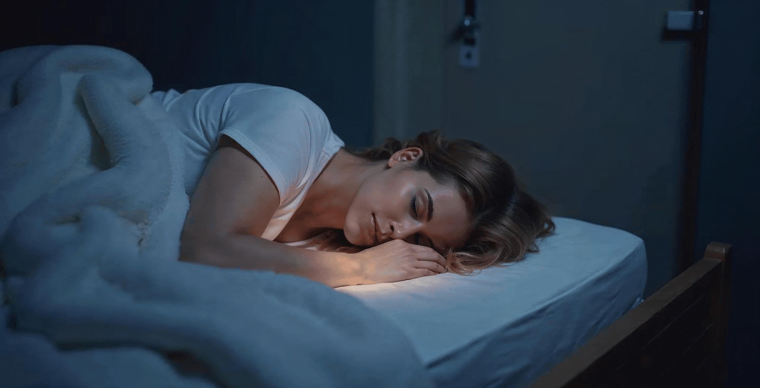 Woman sleeping peacefully under a blanket