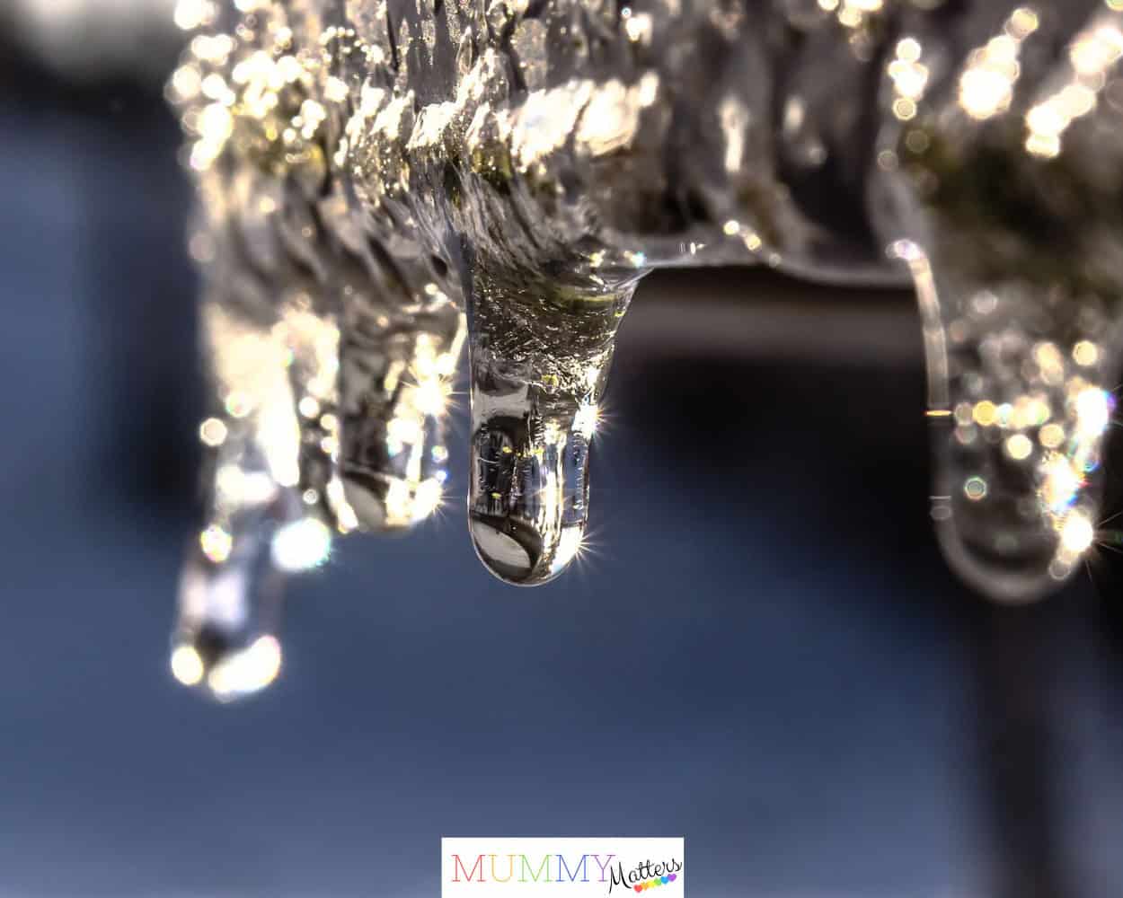 Macro shot of icicles glistening in the sunlight, capturing the essence of winter.
