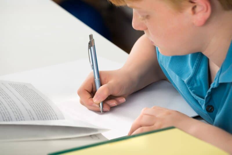 74297950 boy doing his homework