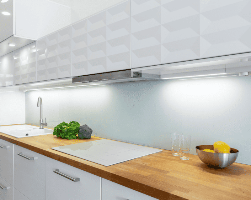 a kitchen with white cabinets and white counter tops