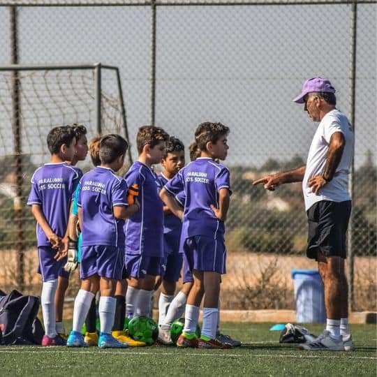 a group of boys in a football field