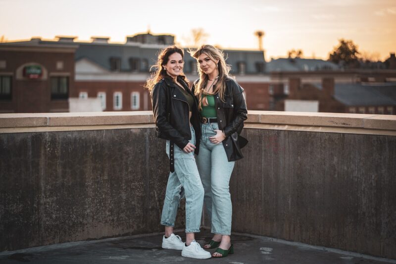two women standing on a ledge