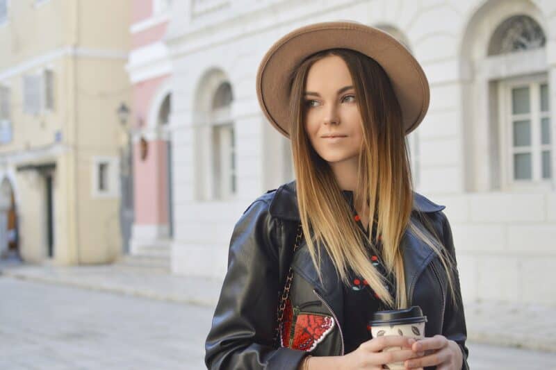 a woman holding a cup of coffee