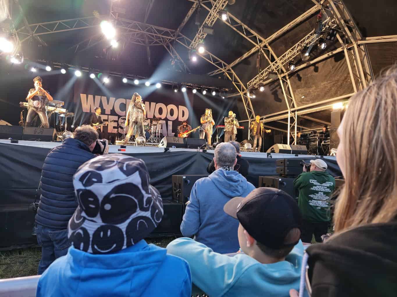 a group of people on stage with a band on stage