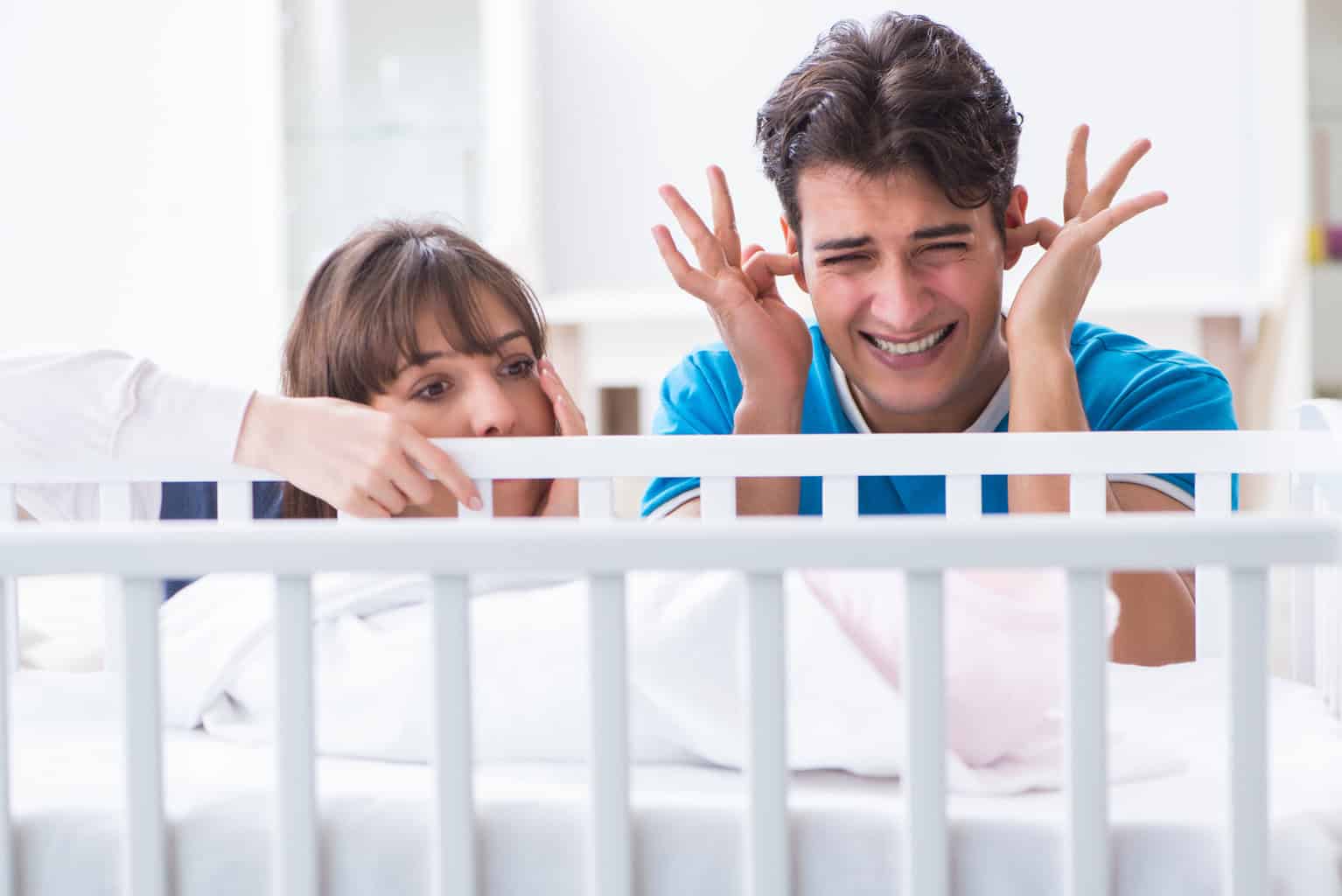 a man and woman in a crib