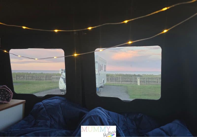 View of the sea from inside the back of the campervan