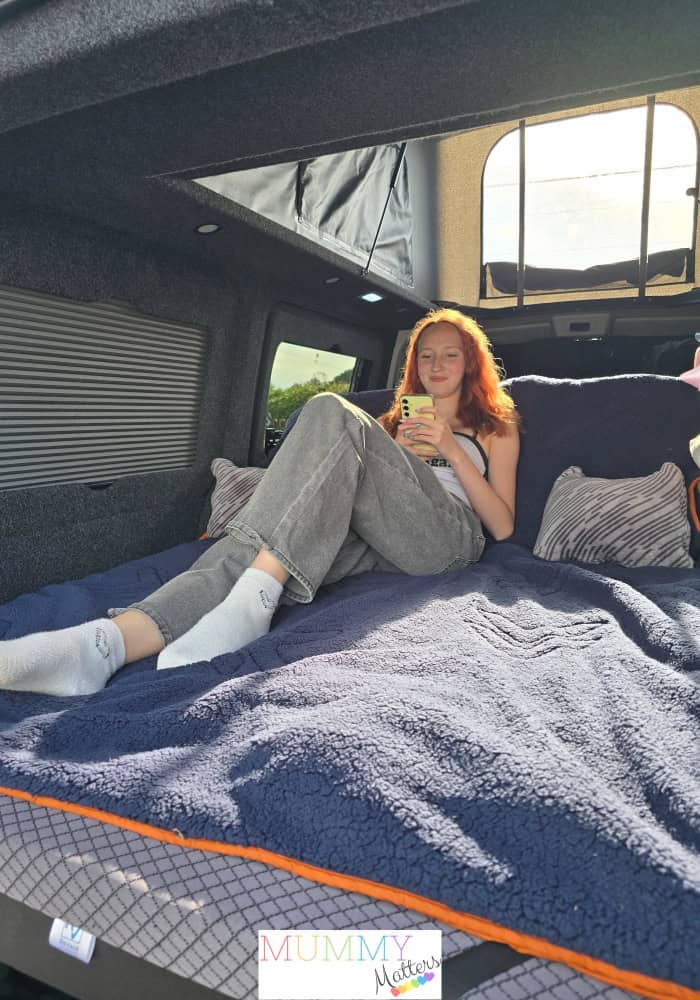 Girl relaxing in VW T6 Campervan
