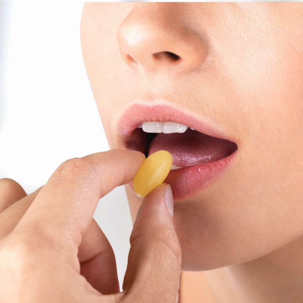 woman taking a sore throat lozenge