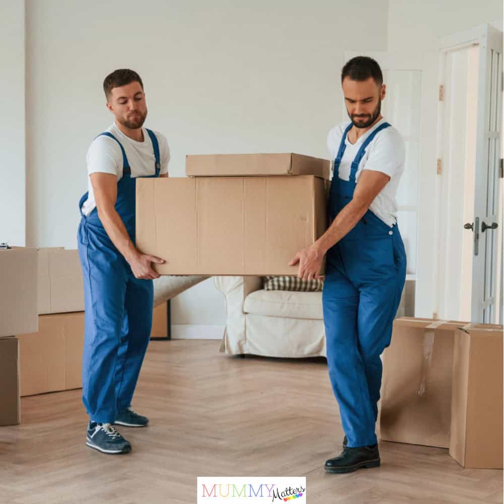 One big heavy box two moving service employees in a room