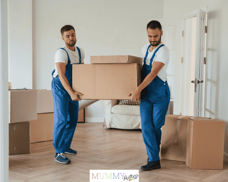 One big heavy box two moving service employees in a room