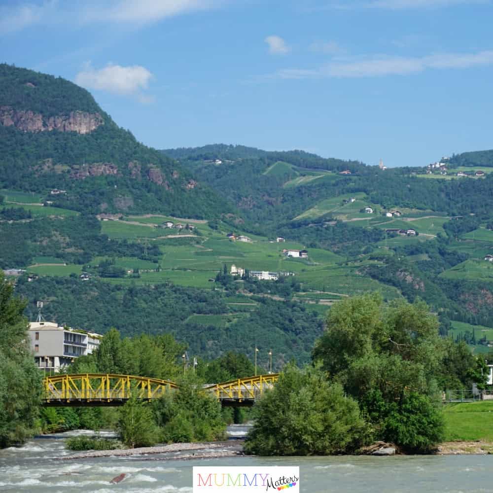 Rolling green countryside vista with scenic river in the foreground