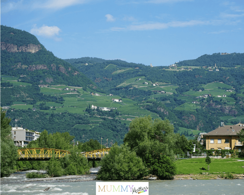 View of green hills with scenic river in the foreground