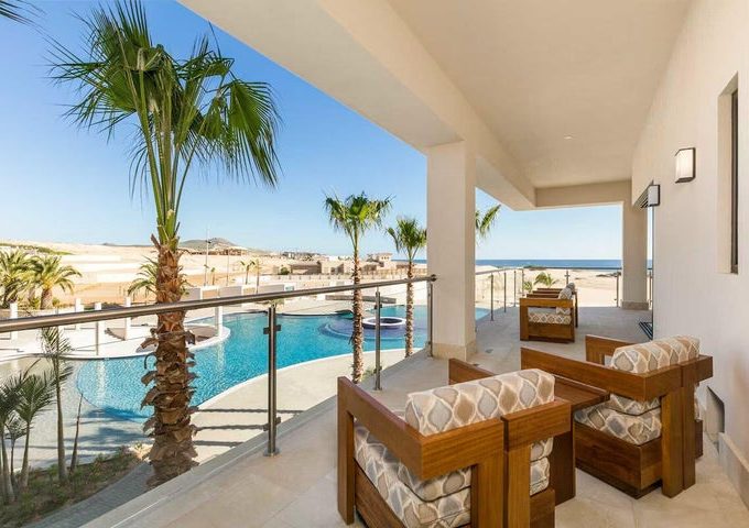 Luxury Balcony View Overlooking The Infinity Pool And Pacific Ocean At Diamante Beaches And Pools In Los Cabos.