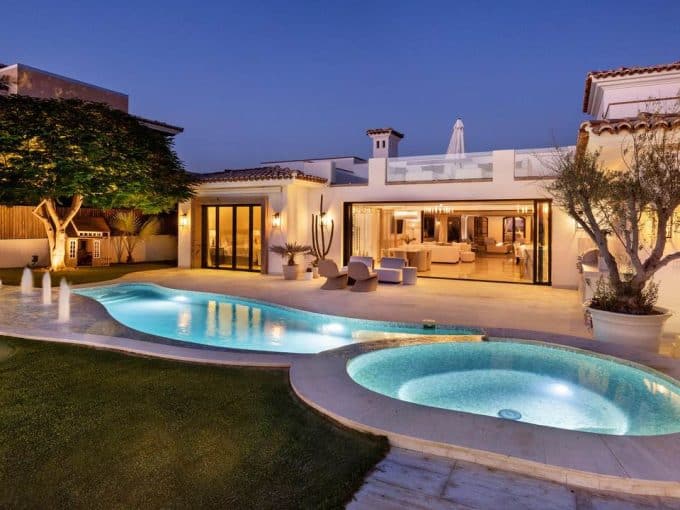 Luxurious Diamante Cabo San Lucas Real Estate With Illuminated Pool And Elegant Outdoor Living Spaces At Sunset.