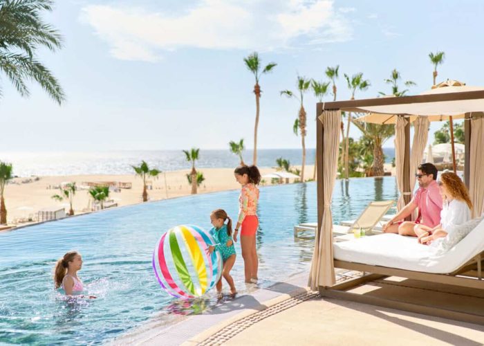 Family &Amp; Kids β Homes For Sale In Diamante Relaxing Tropical Poolside Scene At Diamante Cabo San Lucas With Families Enjoying The Water And Sunbeds With Ocean Views.