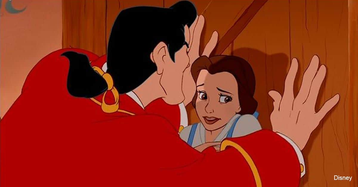 A nervous woman stands trapped by a cast member in red at Disneyland, anxiously awaiting her princess audition.