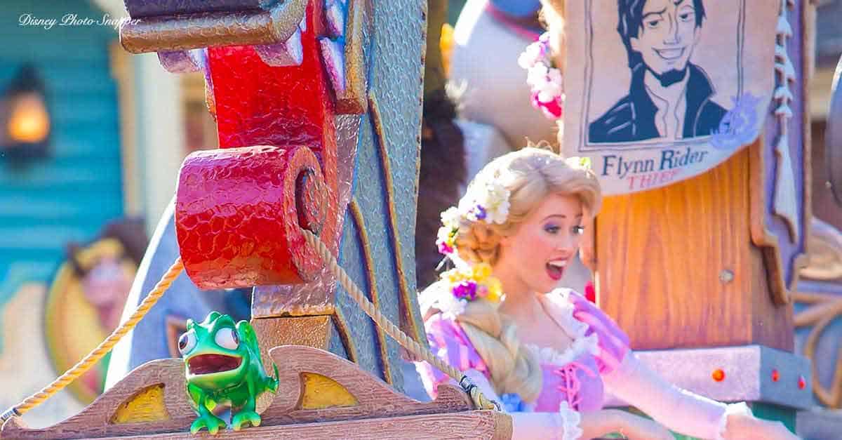 Rapunzel and Pascal from Tangled delight fans in a vibrant Disney parade, with a Flynn Rider poster adding to the fairytale fun.