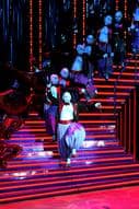 A group of dancers on a stage in a theater.