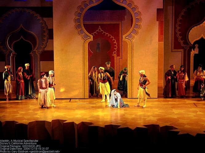 Aladdin and cast dazzle the crowd in vibrant costumes on a stage of golden arches during Disney California Adventure’s hit Musical Spectacular.