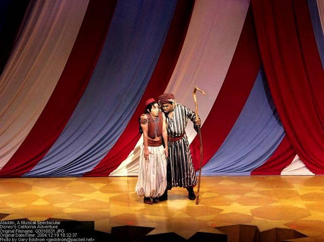 Dazzling performers light up the stage beneath patriotic red, white, and blue curtains for an unforgettable theater show.