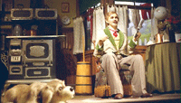 A Carousel of Progress scene with the father animatronic in a retro kitchen, and a dog lying on the floor at his feet.