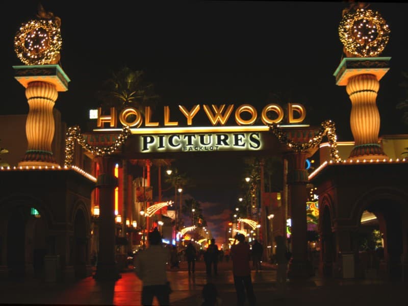 The entrance to hollywood pictures at night.