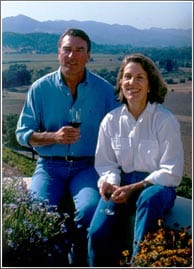 Guests at Silverado Vineyards relax with wine, smiling and enjoying panoramic vineyard and mountain views like a scenic park attraction.