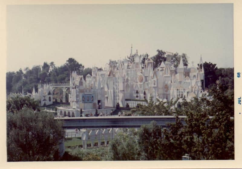 Disneyland’s "it’s a small world" facade, sparkling white and surrounded by lush trees, July 1968.