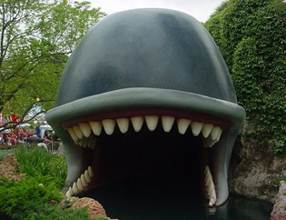 Iconic whale statue with a wide open mouth and jagged teeth greets guests at the entrance to Adventure Land.