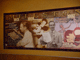 A vibrant mural shows Disney animators at work with classic characters, like Minnie Mouse in red, capturing Disney magic in action.