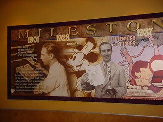 A vibrant Disney Animation mural showcases Walt Disney milestones, with Mickey Mouse and "Flowers and Trees" at the center.