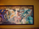 Vibrant mural of beloved Disney Animation characters framed in brown, capturing the magic of classic Disney parks.