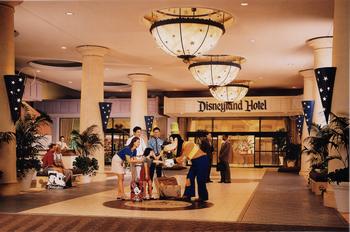 Guests and Cast Members mingle in the bustling Disneyland Hotel lobby, ready to immerse themselves in the Disney magic.