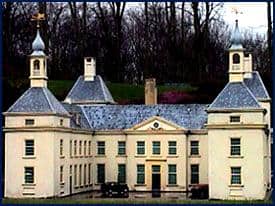 A grand, Disney-style mansion with twin towers and a grey roof, evoking classic theme park haunted house vibes.