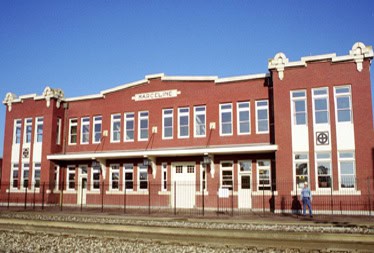 Charming red brick station with grand windows and a marquee, now the Walt Disney Hometown Museum—honoring Disney magic’s roots.