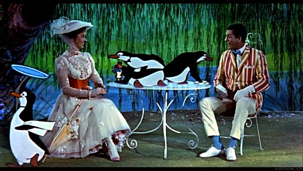 Guests dressed in vintage attire join playful penguins at an outdoor table, capturing the magical Mary Poppins vibe of Disney parks.