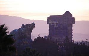 Hollywood Tower Hotel silhouette with mountain backdrop at sunset, ideal for fans of Disney park thrills and immersive wallpapers.