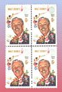 Four stamps show Walt Disney smiling alongside classic Disney characters, set against a vibrant background honoring his legacy.