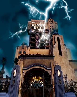 Lightning crackles over the Hollywood Tower Hotel, casting eerie light on the Tower of Terror’s iconic gate and stormy night sky.