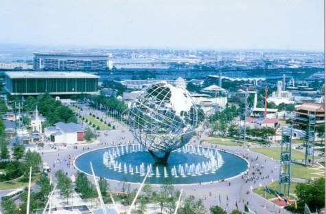 Iconic globe sculpture and fountains at Disneyland, evoking classic park magic with visitors and Downtown Disney buildings nearby.
